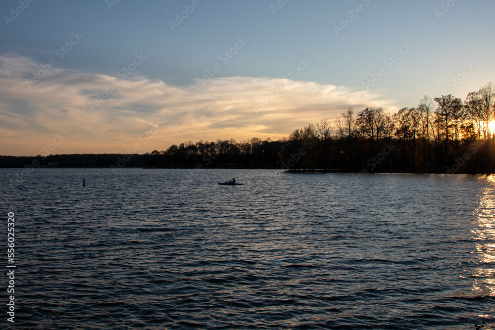 Person in Kayak in Lake Anna Virginia Paddling Across the Lake on a Fall Day at Sunset
