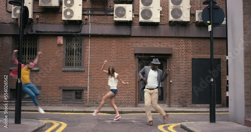 Dance, people and street performance in city by group training for theatre, practice and rehearsal against building background. Art, dancer and group with energy, motion and street dance in New York
