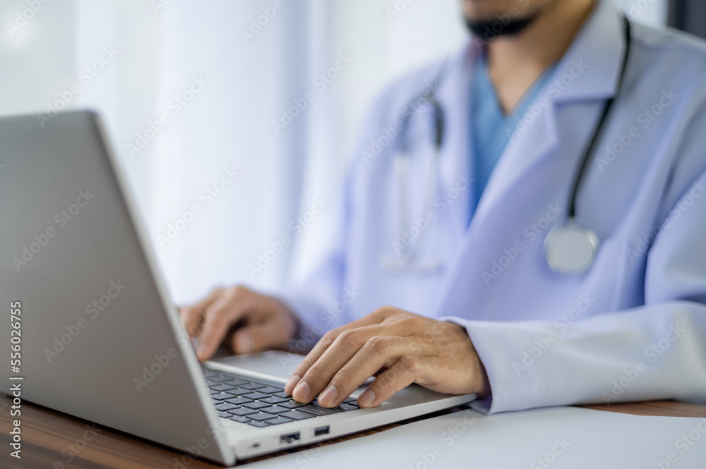 People using computer Side view of male hands typing on laptop keyboard People using computer Side view of male hands typing on laptop keyboard