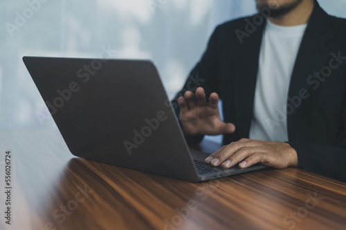 People using computer Side view of male hands typing on laptop keyboard