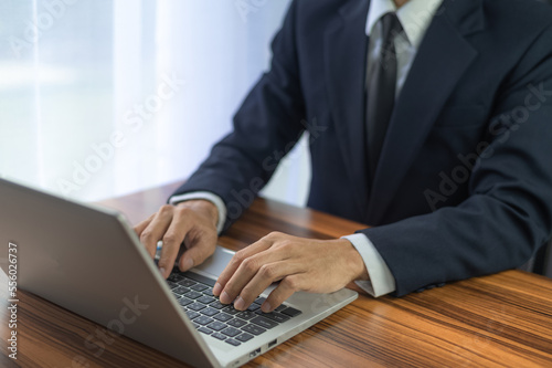 People using computer Side view of male hands typing on laptop keyboard