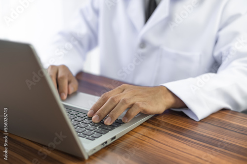 People using computer Side view of male hands typing on laptop keyboard