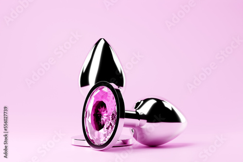 3D illustration.  Silver  butt anal plugs sex toys on  pink background. photo