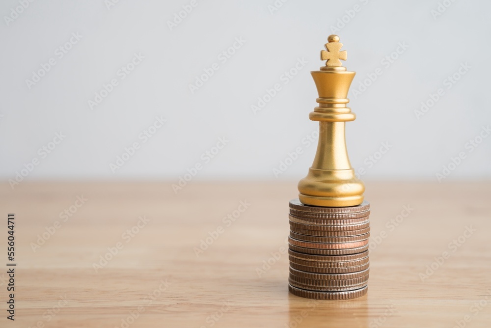 King chess on stacked coins as growth profit up graph chart on wooden table with white wall background copy space. Business, investment good strategy or planning for achieve successful profit target. King chess on stacked coins as growth profit up graph chart on wooden table with white wall background copy space. Business, investment good strategy or planning for achieve successful profit target.