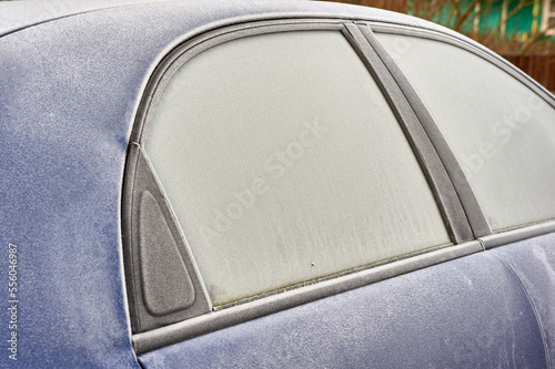 frozen windshield of a passenger car in winter