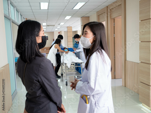 doctor nurse female person talk speak discussion woman lady people indoor room hospitalclinic laboratory wear mask. emergency word accident health care treatment visit family teamwork medical  photo