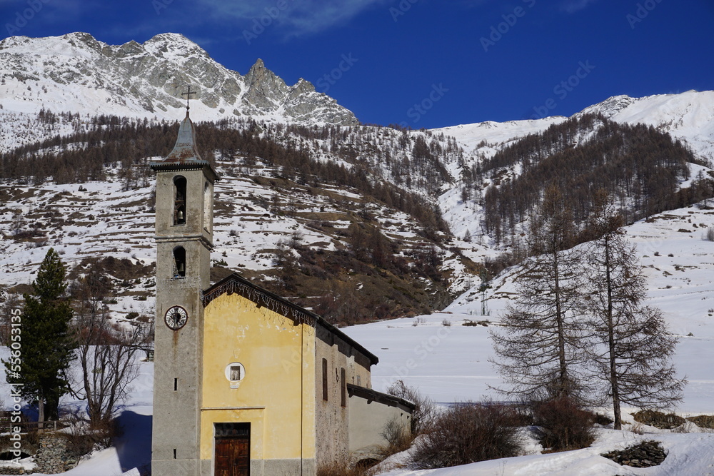 old stone church in the mountains  by the snowy peak in the southern Alps, France