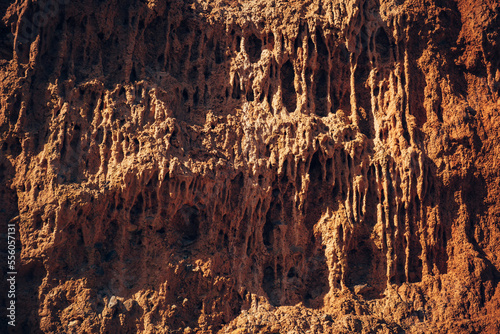 Red brown rock texture. Rough mountain surface, close-up. Natural stone pattern.