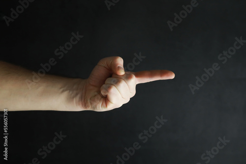 Male hands on a gray background. Finger gestures. Gesticulation with hands.