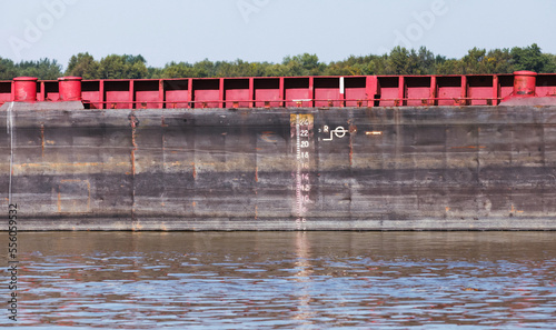 Hull of a bulk carrier ship with draft scale, background photo photo