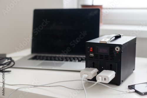 Charging station for phone, tablet, laptop and other gadgets when there is no light during blackout. Generator power bank battery in the absence of electricity. Charge electric rechargeable battery