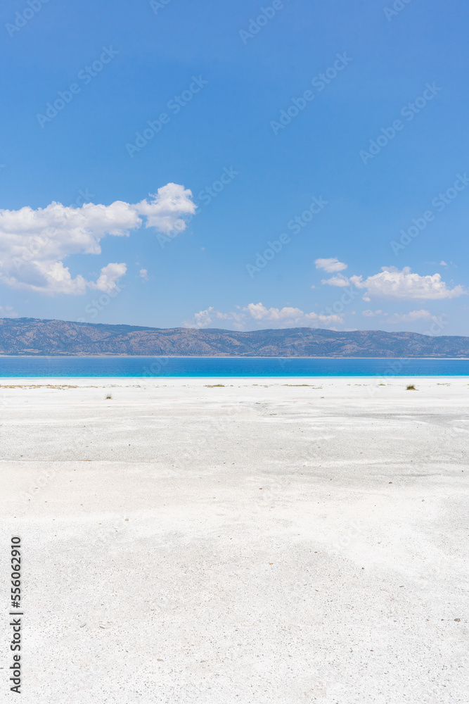 Obraz premium The turquoise waters of Salda Lake, the white mineral-rich beach and the blue sky. Salda Lake is a turquoise crater lake. Salda Lake, Burdur, Turkey