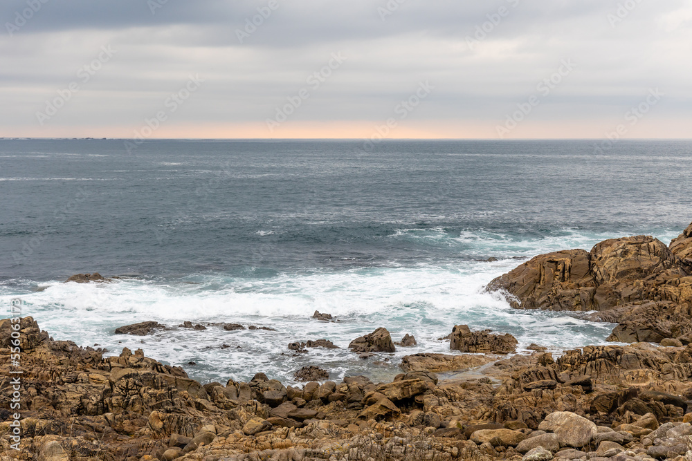 waves crashing against the rocks in the atlantic ocean in the town of Baiona, Galicia, Spain waves crashing against the rocks in the atlantic ocean in the town of Baiona, Galicia, Spain