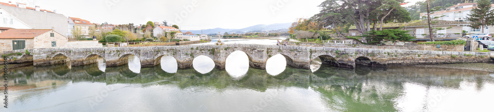 Baiona, Spain - December 05, 2022: Romanesque bridge of La Ramallosa that connects the towns of Nigran and Baionan in the town of Baiona, Spain