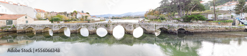 Baiona, Spain - December 05, 2022: Romanesque bridge of La Ramallosa that connects the towns of Nigran and Baionan in the town of Baiona, Spain