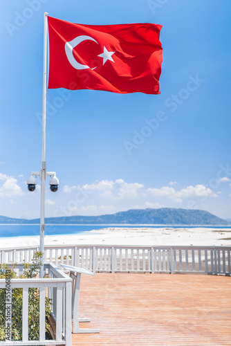 Turkish flag waving in Salda lake. Turquoise waters and blue sky of Salda Lake. Salda Lake is a turquoise crater lake.
Burdur, Turkey