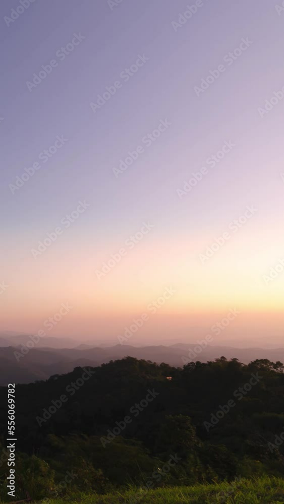 vertical timelapse view of Sunset in over natural winter mountain range with some cloud fog.Flores tropical paradise. Mountain Range Silhouette Sunrise Sunset Aerial View. vertical timelapse view of Sunset in over natural winter mountain range with some cloud fog.Flores tropical paradise. Mountain Range Silhouette Sunrise Sunset Aerial View.