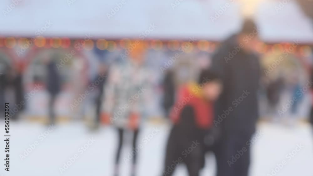 Defocused ice skating rink with a crowd of ice skaters. Blurred background. Defocused ice skating rink with a crowd of ice skaters. Blurred background.