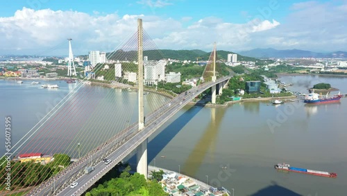 Aerial view of Bai Chay bridge and smooth traffic during the day with blue sky and clouds photo