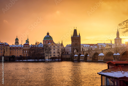 Beautiful winter sunrise view of the skyline of Prague with Charles Bridge and the snow covered old town roofs, Czezch republic  photo