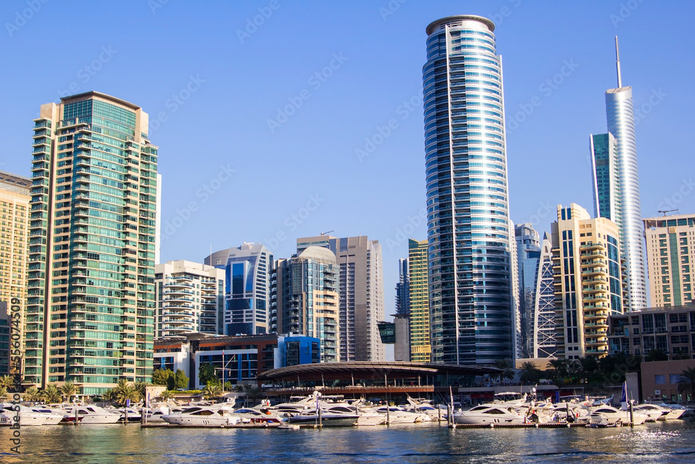 Obraz premium photo background view of the yacht club in Dubai Marina and the water of the bay, and residential buildings around, Dubai, United Arab Emirates
