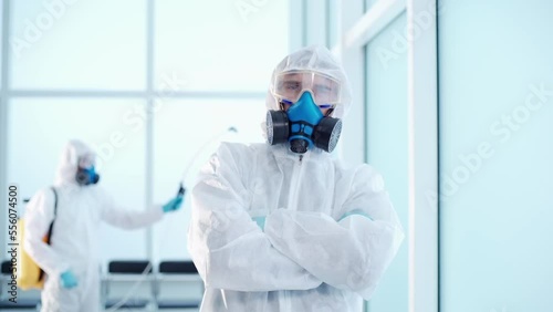 disinfector in a biohazard suit standing in an infected room. photo