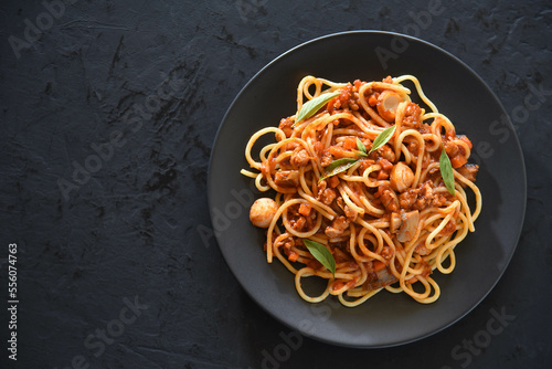 Spaghetti plate on black stone background and space for text.
