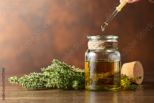 Obraz na plátně Bottle of thyme essential oil with fresh thyme.