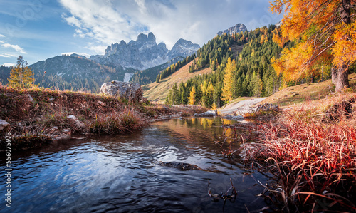 Scenic image of mountains. Great view on alps, calm river, colorful forest on the alpine highland during sunset. Wonderful Nature landscape. Travel is a Lifestyle, concept. Amazing, autumn scenery.