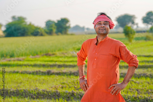 Young Indian farmer giving expression at agriculture field. © Niks Ads