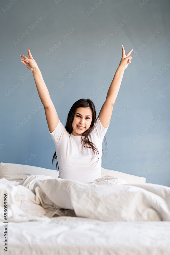 young beautiful brunette woman sitting awake in bed young beautiful brunette woman sitting awake in bed
