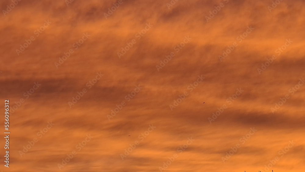 Genova, Italy-November 19, 2022:bBautiful sunset reflection of sky with sundown.The sky with nightfall majestic sundown.Colorful sunset with red and orange colours.