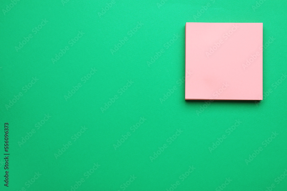 Empty notes on green background, top view. Space for text Empty notes on green background, top view. Space for text