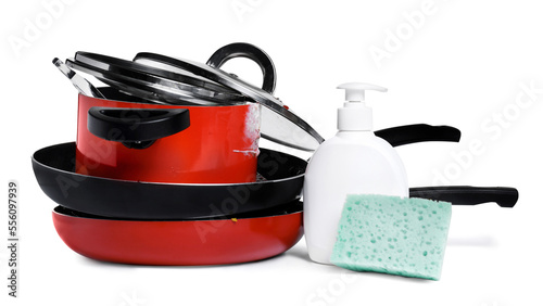 Stack of dirty kitchenware, dish detergent and sponge on white background