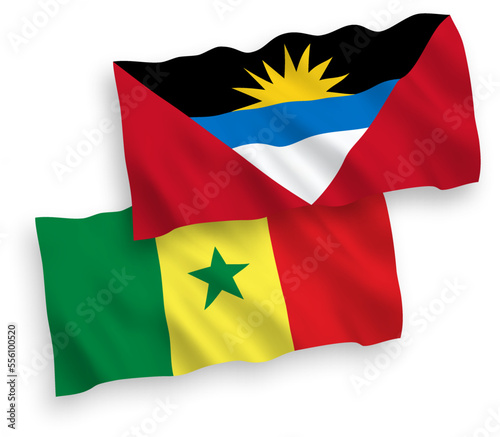 National vector fabric wave flags of Republic of Senegal and Antigua and Barbuda isolated on white background. 1 to 2 proportion.