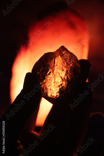 Beautiful precious citrine crystal on a salt lamp background.