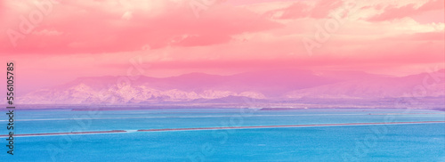 Dead Sea beach. Seascape during sunrise. Salt sea coast in Israel. View of Mount in Jordan. Gradient Color. Horizontal Banner
