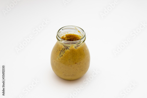 Dijon mustard in a glass jar on a white background. spicy seasoning