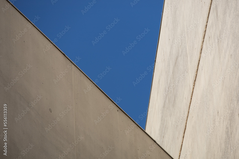 Modern architecture, concrete walls with blue sky - geometric shape Modern architecture, concrete walls with blue sky - geometric shape