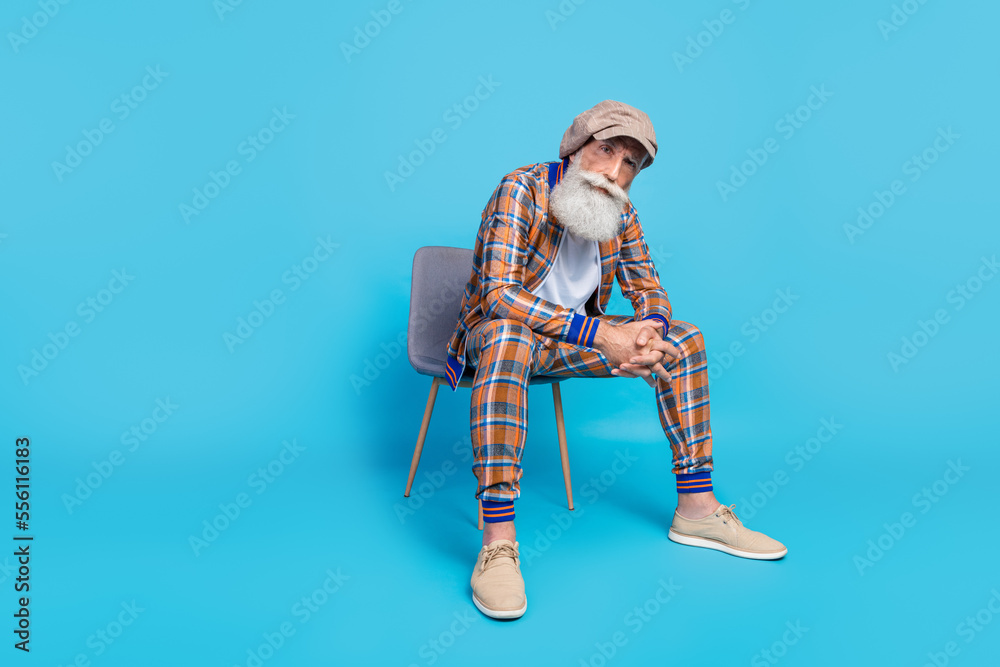 Photo of successful man wear trendy checkered suit promoting new collection clothes empty space isolated on blue color background Photo of successful man wear trendy checkered suit promoting new collection clothes empty space isolated on blue color background