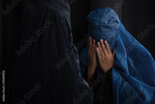Muslim woman in Burka or Burqa, tradition cloths in Afghanistan and west Pakistan greeting to each other, Salam, As-salamu alaykum, Peace be upon you, black background