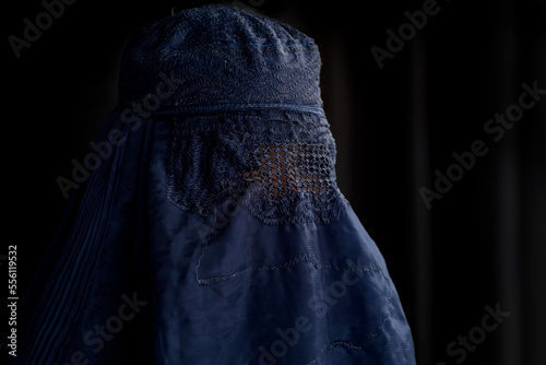 Close up, Muslim woman in Burka or Burqa, tradition cloths in Afghanistan and West Pakistan, Muslim women wear a burqa covering her face and body, Black background
