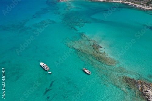 The Beautiful ultra wide top down photo of luxury yacht in turquoise sea