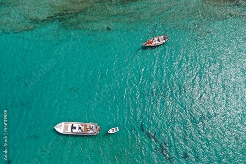 The Beautiful ultra wide top down photo of luxury yacht in turquoise sea