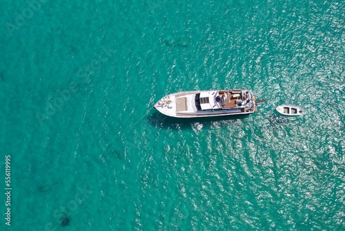 The Beautiful ultra wide top down photo of luxury yacht in turquoise sea © Rafik