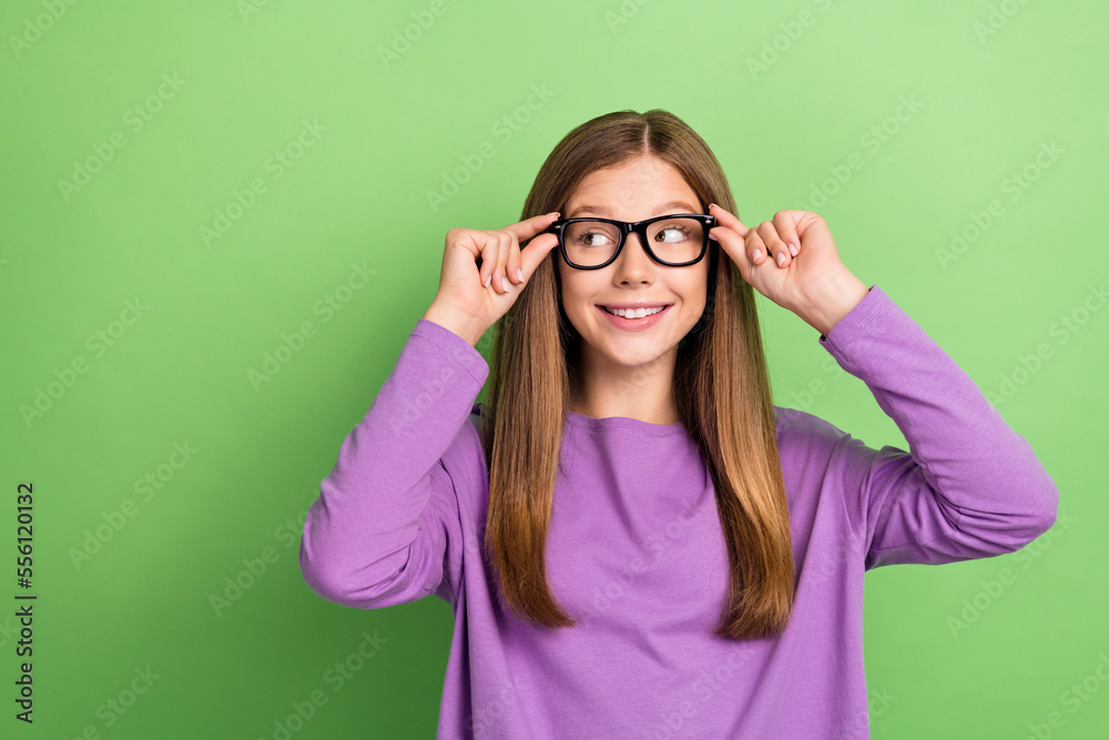 Photo of intelligent pretty lady wear stylish clothes look empty space promoting eyewear isolated on green color background Photo of intelligent pretty lady wear stylish clothes look empty space promoting eyewear isolated on green color background