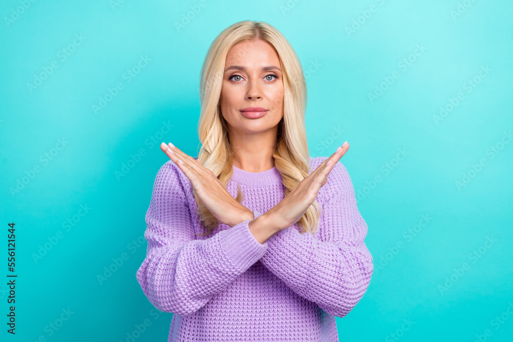 Photo of focused confident person crossed arms demonstrate stop gesture isolated on cyan color background Photo of focused confident person crossed arms demonstrate stop gesture isolated on cyan color background
