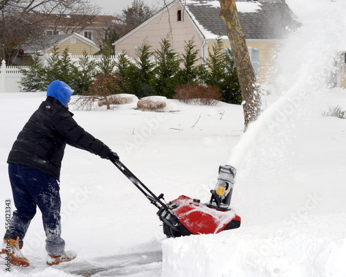 Winter storm clearing with snowblower