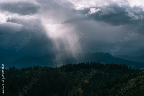 Dramatic landscape, sunbeams breaking through the clouds © teksomolika