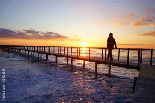Man walking on Todowara Walk Path and Frozen Ocean at Notsuke Peninsula in Betsukai, Hokkaido, Japan - 日本 北海道 別海町 野付半島 トドワラ 探勝線歩道 氷海 歩く男性